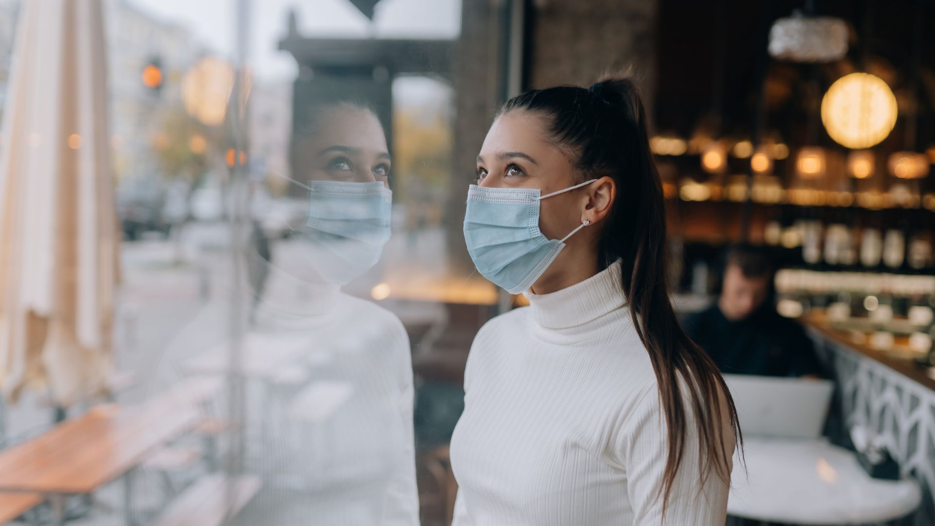 young lady wearing covid mask at hotel